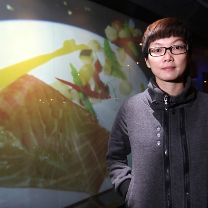 Developer Crystal Fok Lo-ming demonstrates video glass technology in Causeway Bay. Photo: K. Y. Cheng/SCMP