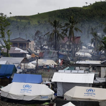 UNHCR tents and makeshift shelters in a typhoon devastated village in Samar. Photo: EPA