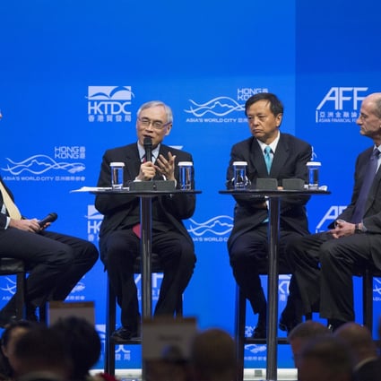 CIC International chairman Lawrence Lau (second left) speaking at the forum with (left) Mark McCombe, Asia-Pacific chairman of BlackRock, (second right) Charles Li, chief executive of HKEx, and (right) General Electric vice-chairman John Rice at the forum. Photo: Bloomberg