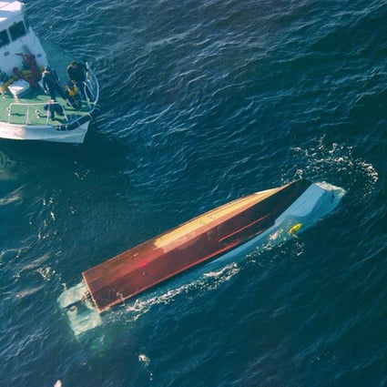 The Japanese Coast Guard approach the capsized fishing boat after its collision with the Osumi warship. Photo: EPA