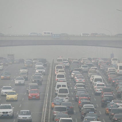 Vehicles queue in the business district of Beijing at noon yesterday, where the smog cut visibility to as low as 500 metres. Photo: Simon Song