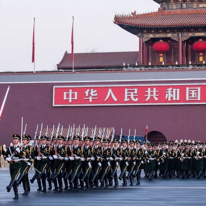 Chinese national flag guards escort the flag across the Chang'an Avenue in Beijing on January 1, 2014. Photo: Xinhua
