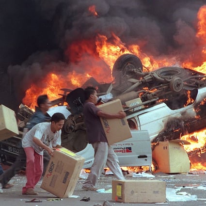 This 1998 photo shows angry Indonesian mobs burning cars and Chinese shops as they plundered shops in Jakarta. Photo: AFP