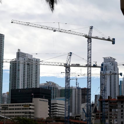 Cranes are seen against the skyline as condos are built in Miami.