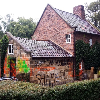 Graffiti sprayed on the exterior of Captain Cook Cottage in Melbourne. Photo: EPA