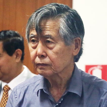 Jailed former President Alberto Fujimori enters the courtroom at a police base in Lima. Photo: AP