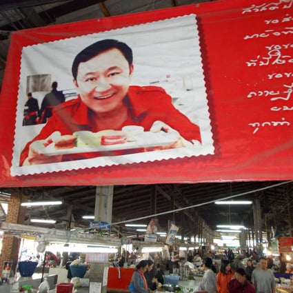 A market in Thaksin Shinawatra's hometown of San Kamphaeng, near Chiang Mai, displays a photograph of him. Photo: Tom Fawthrop