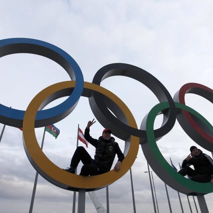 Two men sit inside a set of Olympic rings on display at the Olympic Park as preparations continue for the Sochi 2014 Winter Olympics Photo: REUTERS