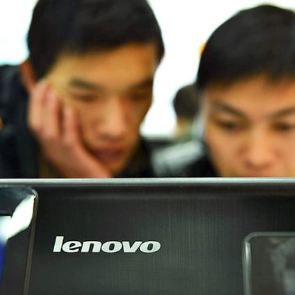 Customers check out computers at a Lenovo shop in Hangzhou. Photo: AFP