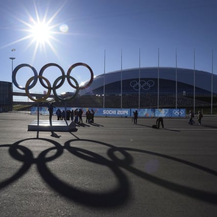 People pose in front of the Olympic rings near the Bolshoy arena in the seaside cluster prior to the start of the 2014 Sochi Winter Olympics. Photo: AFP
