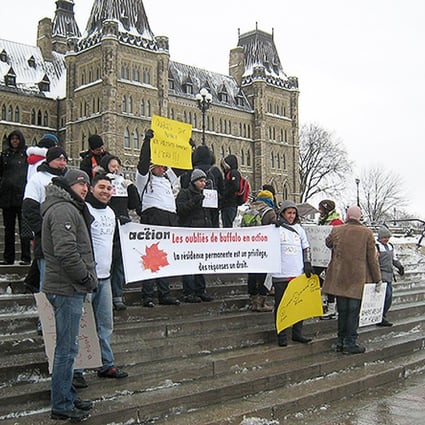 Protesters gather in front of the Canadian parliament in Ottawa as thousands of immigrants pressed Canada's government to fast-track their permanent residency applications. Photo: AFP
