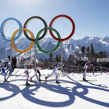 Norway's Marit Bjoergen leads as she skis past the Olympic rings on her way to winning the women's cross-country 15km skiathlon. Photo: AP