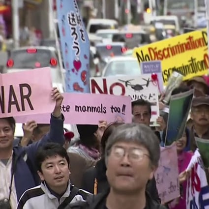 Protesters march against the relocation plan of the US base in Naha, Okinawa. Photo: AP