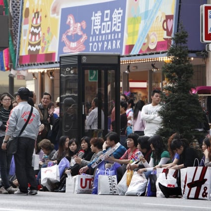 Mainland tourists take a break after shopping in Tokyo's Ginza district. Photo: AP
