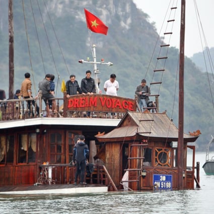 The sunken boat Dream Voyage is being salvaged in Ha Long Bay. Photo: EPA