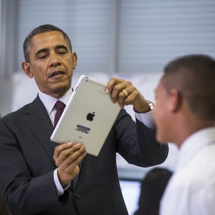 US President Barack Obama uses an Apple iPad tablet computer to record a seventh grader in Maryland in February. Photo: EPA