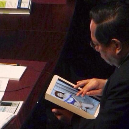 Lawmaker Albert Ho Chun-yan was caught browsing photos of models as the Financial Secretary John Tsang was giving his budget speech at the Legislative Council. Photo: SCMP Pictures