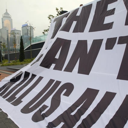An HKJA banner is unfurled at Tamar. Photo: Felix Wong
