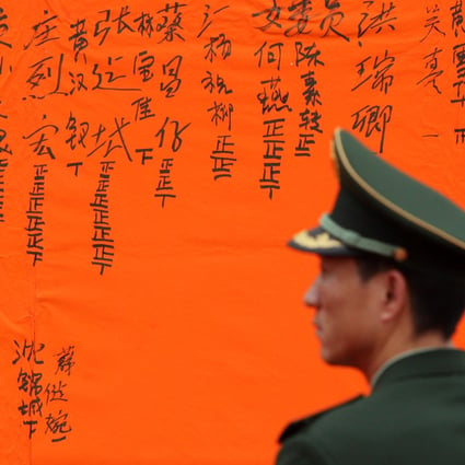 A paramilitary policeman watches the vote canvassing during Wukan's landmark elections in 2012. Photo: Felix Wong