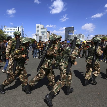 Paramilitary policemen patrol after a knife attack near Kunming railway station in Kunming. Photo: Reuters