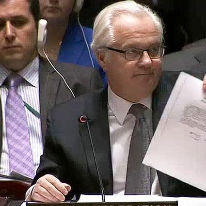 Vitaly Churkin, Russia's ambassador to the UN, shows a letter to purportedly from ousted Ukrainian leader Viktor Yanukovich to Vladimir Putin asking the Russian leader for military intervention in Ukraine. Photo: Reuters