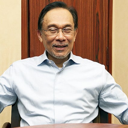Malaysian opposition leader Anwar Ibrahim answers questions about the plane's disappearance in Kuala Lumpur. Photo: SCMP Pictures