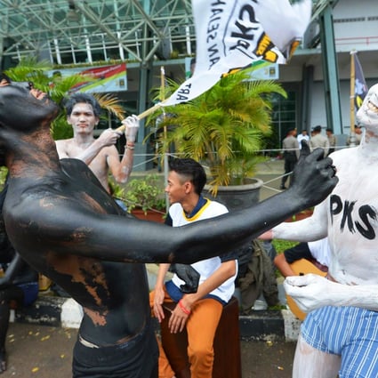 Supporters of the Justice and Welfare Party (PKS) in body paint role play at an election campaign meeting in Jakarta. Photo: AFP