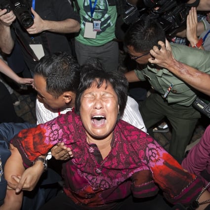 A family member of missing relative from China breaks down as she speaks to the media at Kuala Lumpur International Airport on Saturday. Photo: EPA