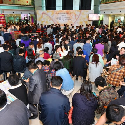 Buyers rush to sign up for the first release of flats at Trinity Towers at the weekend. One-bedroom units sold for as low as HK$3.26 million. Photo: Cheung Kong