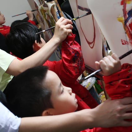 Children paint to the beat of music at the Children's Institute in Kennedy Town. Photo: K. Y. Cheng