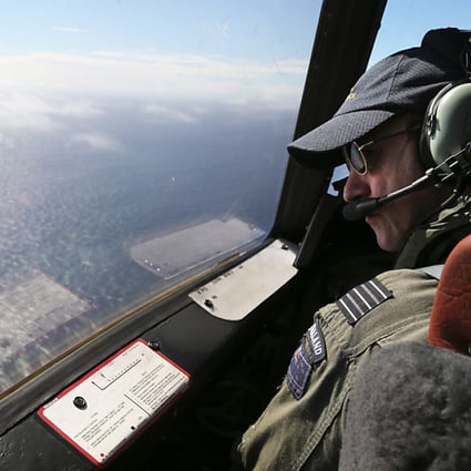 A Royal New Zealand Air Force captain searches for missing Malaysia Airlines Flight MH370 off Perth, Australia on March 31, 2014. Photo: EPA