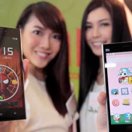 Models show off the newest Xiaomi phone models during a Hong Kong press conference. Photo: Thomas Yau