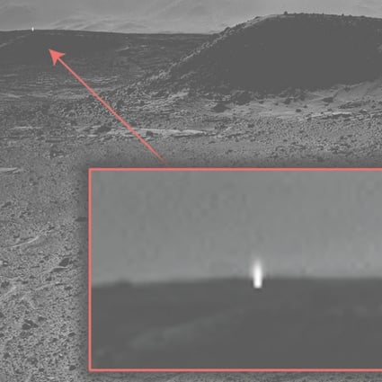 This photo taken by Nasa appears to show a beam of light coming from the surface of Mars
