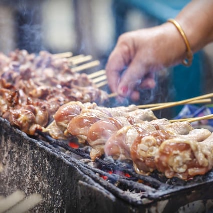 A charcoal grill in use on a street-food stall in Bangkok. Photo: Trizeps Photography