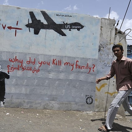 A Yemeni man walks near a graffiti protesting against US drone operations, in Sanaa earlier this month. Photo: EPA