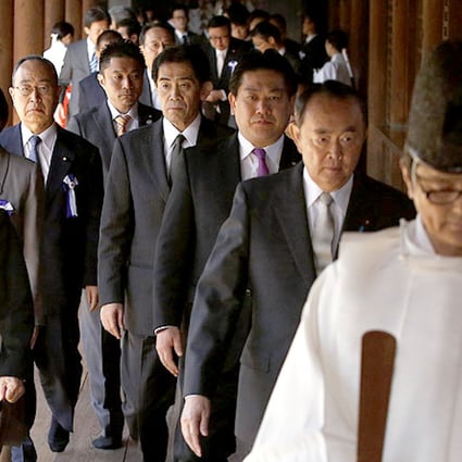 Japanese lawmakers led by a Shinto priest visit the Yasukuni Shrine in Tokyo on Tuesday. Photo: Reuters