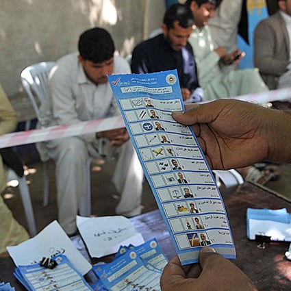 Afghan election workers count ballots at an Independent Election Commission office in Jalalabad on April 16. Photo: AFP