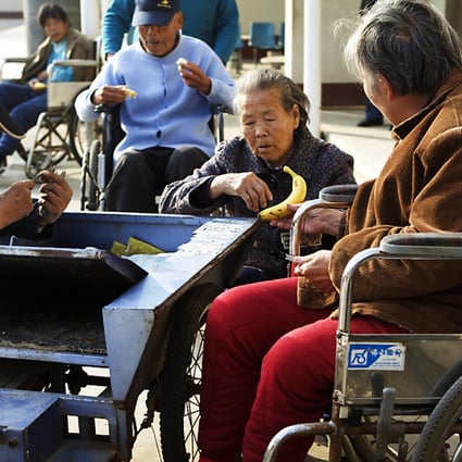 Residents enjoy the sunshine outside flats for the elderly in Beijing. More than 20 per cent of the capital's population are over 60. Photo: Ricky Wong