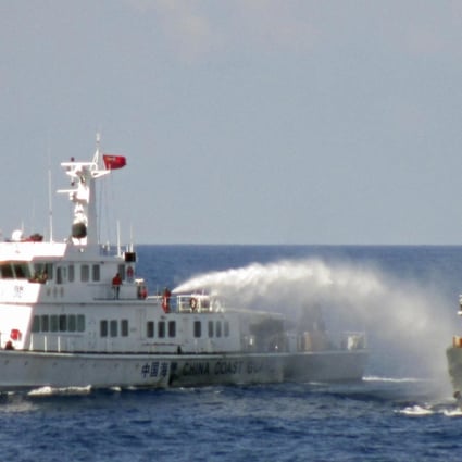 A Chinese coastguard vessel uses water cannon, apparently on a Vietnamese ship. Photo: Reuters