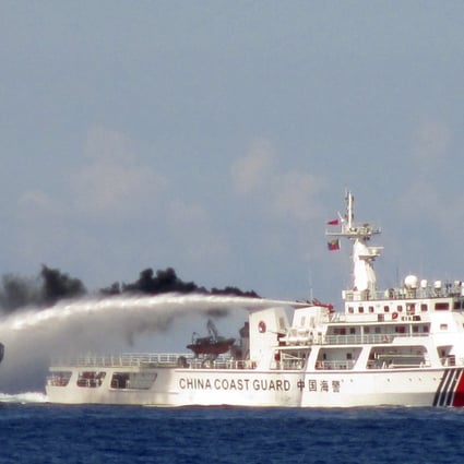A Chinese ship uses water cannon on a Vietnamese Sea Guard ship on the South China Sea near the Paracels islands. Photo: Reuters