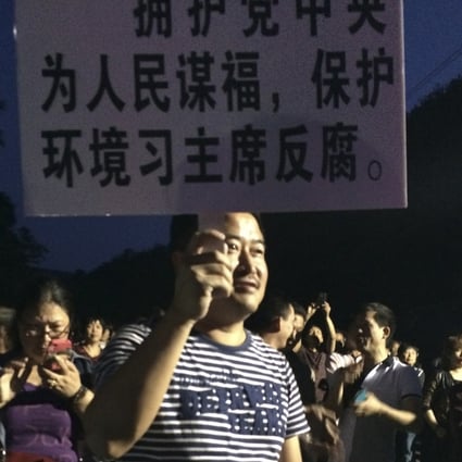 A demonstrator holds a placard during a protest against the construction of a waste incinerator in Hangzhou, Zhejiang province. Photo: Reuters