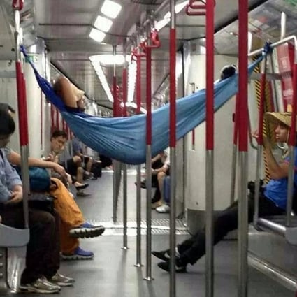 No one seems to notice as this brazen passenger takes a doze in a hammock strung between the seats of an Island Line train on Monday night. Photo: SCMP Pictures