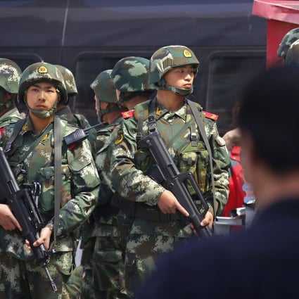 Officers stand guard after the Urumqi attack. Photo: Reuters