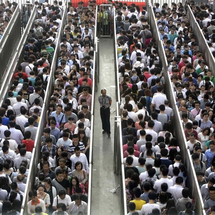 Passengers line up and wait for a security check during morning rush hour at Tiantongyuan North Station in Beijing. Photos: Reuters