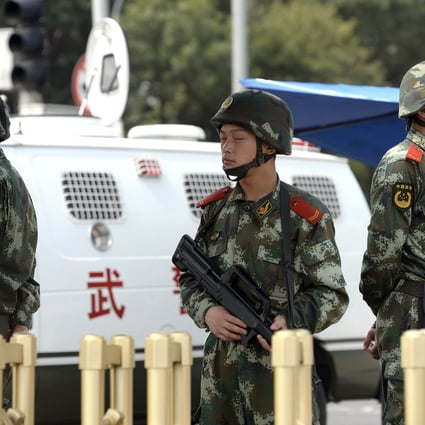 Paramilitary policemen stand guard next to police vehicles in Beijing. Photo: AFP