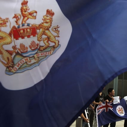 Protesters, carrying former Hong Kong colonial flags, demonstrate against China's intervention and control of the internal affairs of the former British colony, outside the British Consulate in Hong Kong. Photo: Reuters