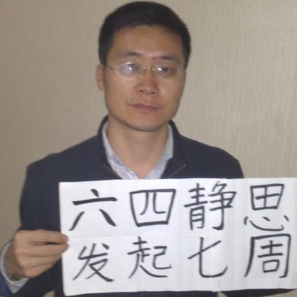 In this photo released by Wang Yanfang, wife of lawyer Tang Jingling, Tang holds a placard with Chinese characters "Seventh anniversary of the June 4 memorial day"at an unknown location in China. Photo: AP