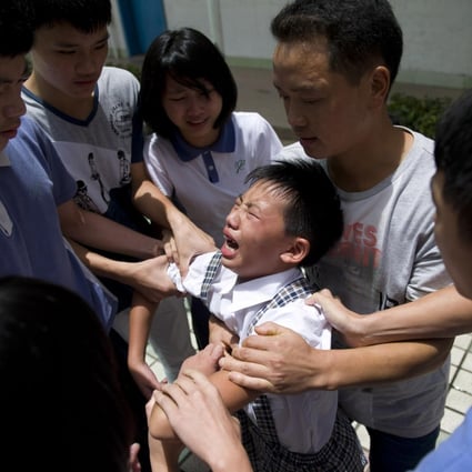 Yang Liujin, 14, cries as Cambridge International Institute students in Shenzhen bid him farewell on Monday. Photo: ChinaFotoPress