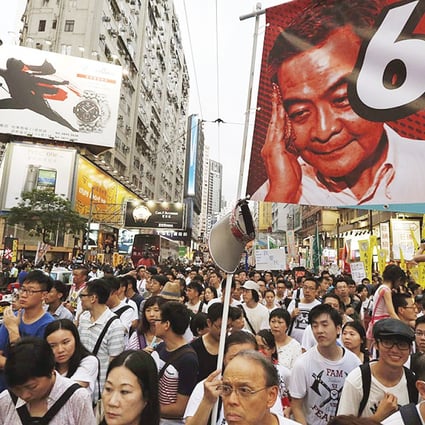 Protesters carry a banner with a portrait of Chief Executive Leung Chun-ying as they join tens of thousands during a march to demand universal suffrage. Photo: Reuters