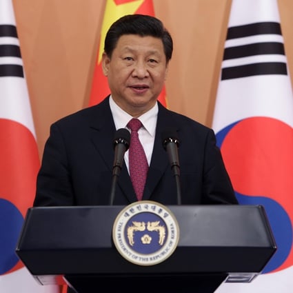 Chinese President Xi Jinping smiles during a meeting in South Korea. Photo: AFP